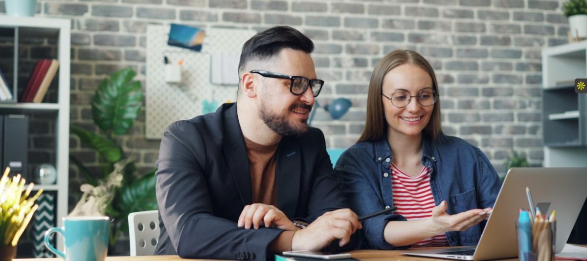 Two colleagues reviewing a candidate together to avoid common legal hiring mistakes