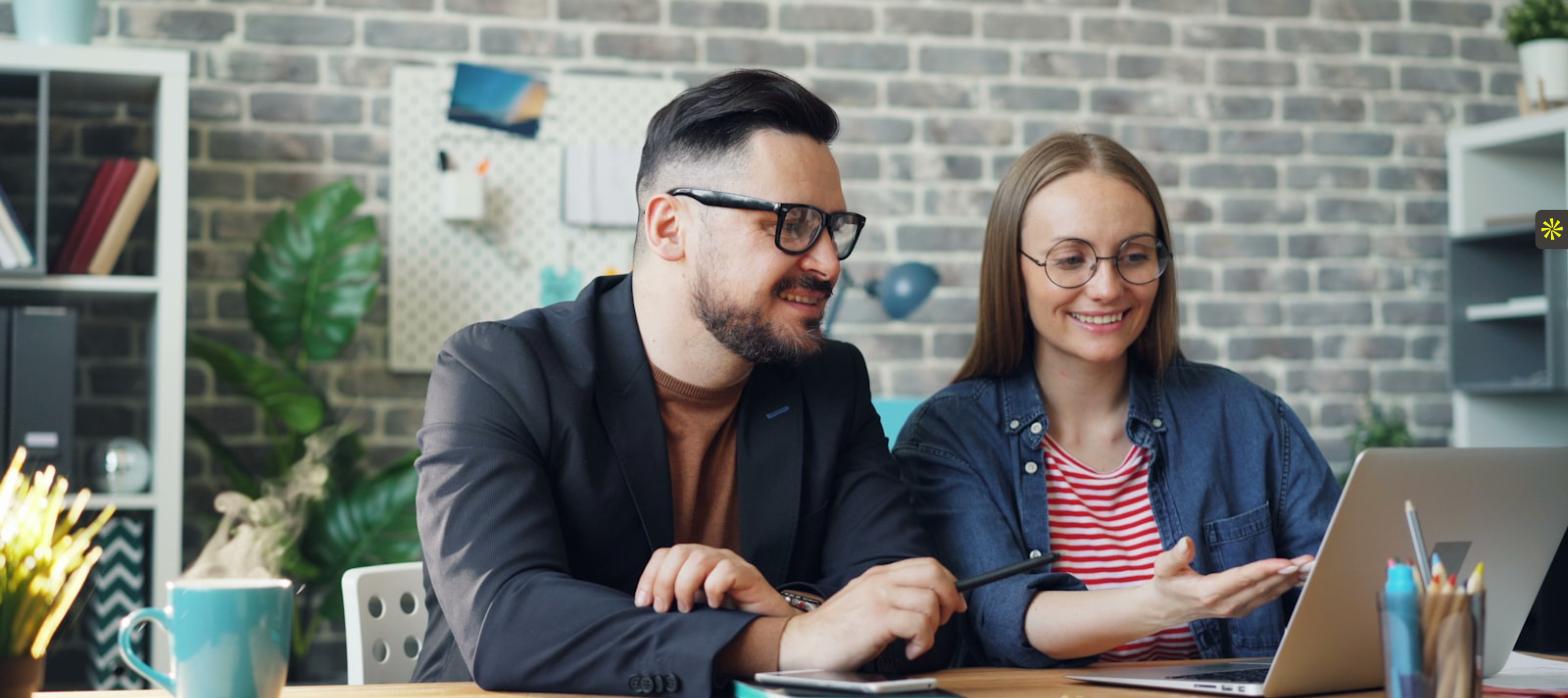 Two colleagues reviewing a candidate together to avoid common legal hiring mistakes