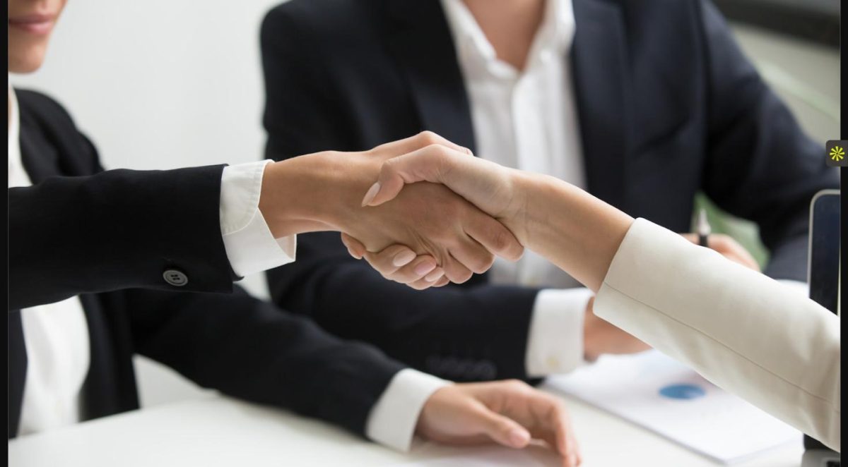 Handshake representing a law firm choosing between temp vs direct hire staffing options